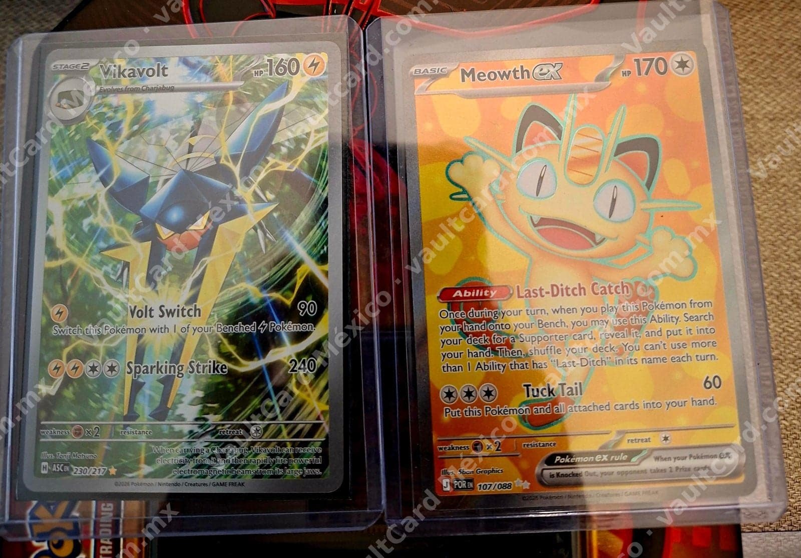 Lote 2 cartas: Vikavolt 230/217 (ASC) + Meowth ex 107/088 (POR) Inglés